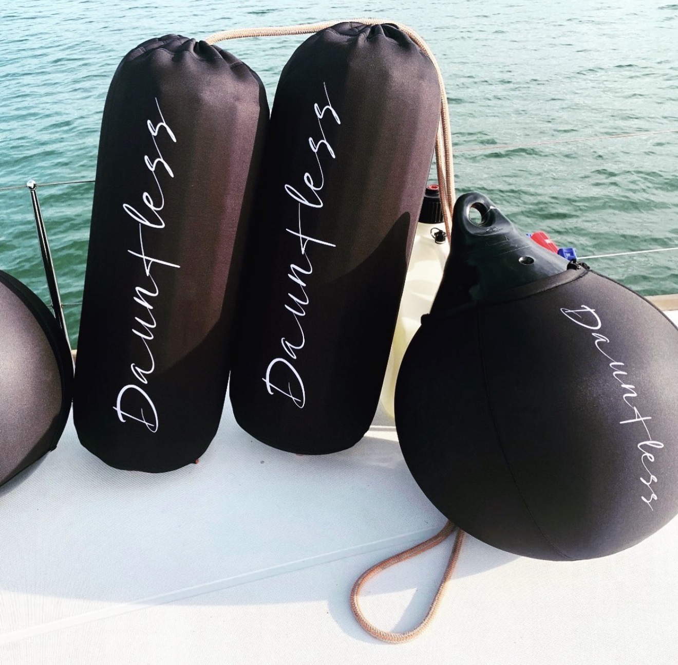 Dauntless script custom fender covers including round buoy fender on open water
